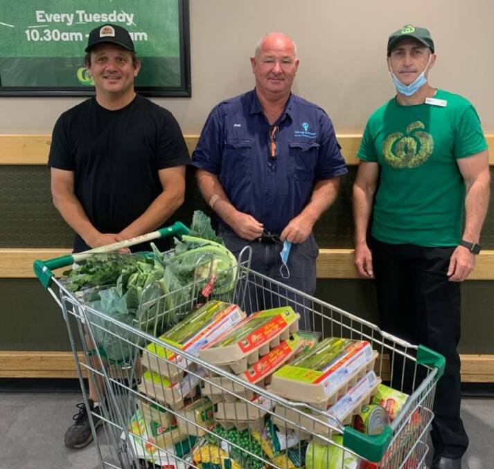 Supported: Brendan Constable (left) and Robert Pollock (centre) accept a huge donation of food from Woolworths ahead of the trip. Photo: Supplied.