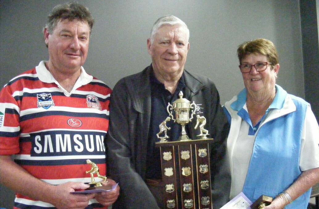 Narooma Bowls: Winners of the NSSC Perpetual Mixed Pairs, Buzz Breust and Sandra Breust, are presented with the trophy by NSSC President, Graham Reeve.