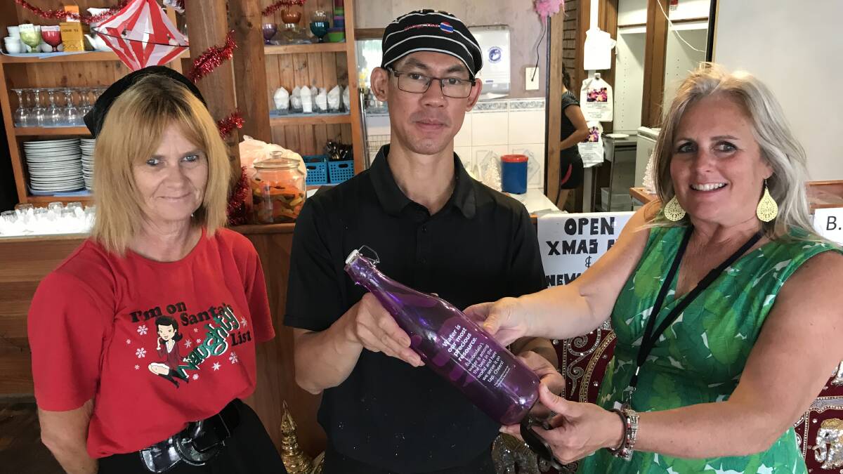TAP WATER: Moruya Thai Restaurant's Cris Barton and Khun Suksing receive their tap water bottle stickers from Gillian Kearney.