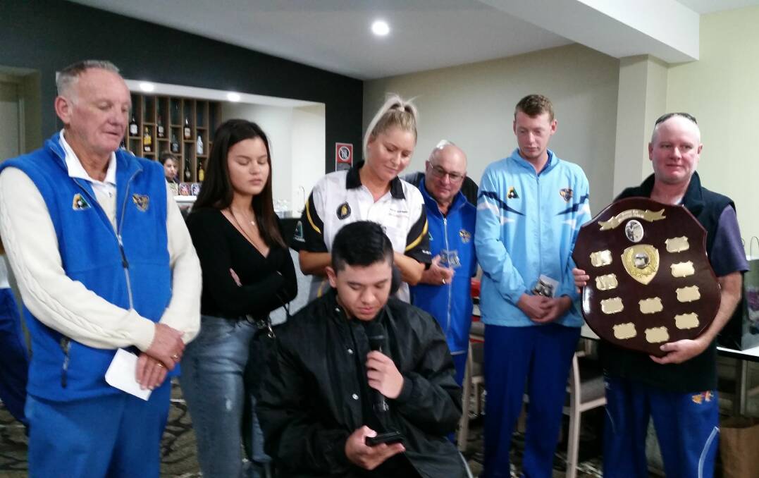 The grandson of Ken Lee, Brandon, along with his sister Tayler and his mother Kya present the Ken Lee Memorial Shield to Martin Cousley's team from Junee.