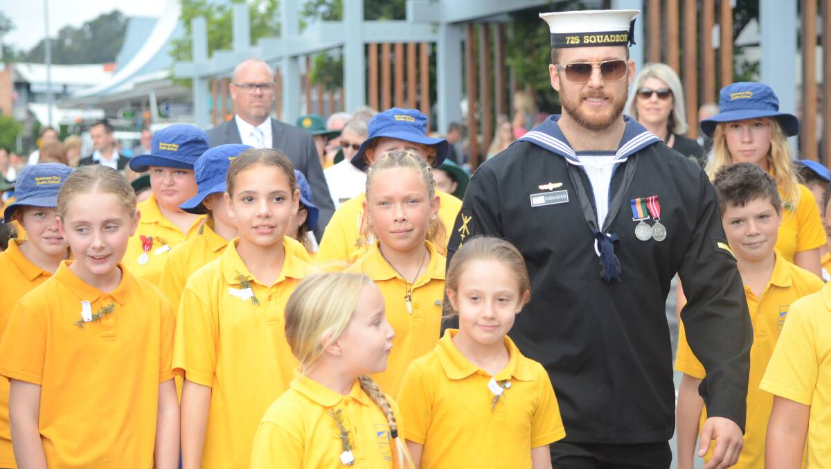 Batemans Bay Public School students with service personnel at the 2019 Batemans Bay Anzac Day march.