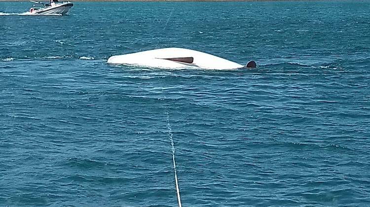 An overturned sailing boat capsized at Chain Bay. A 76-year-old man was rescued. Picture: Marine Rescue NSW.