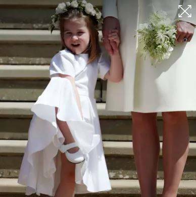  Princess Charlotte looks at Meghan Markle and Britain's Prince Harry. Photo: AP

