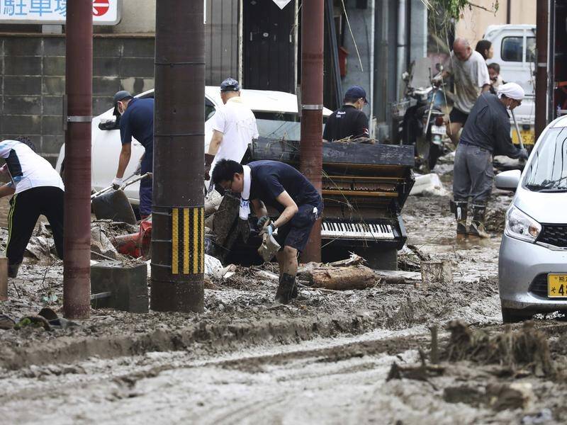 Torrential rain in western Japan has caused flooding and killed 20 people.