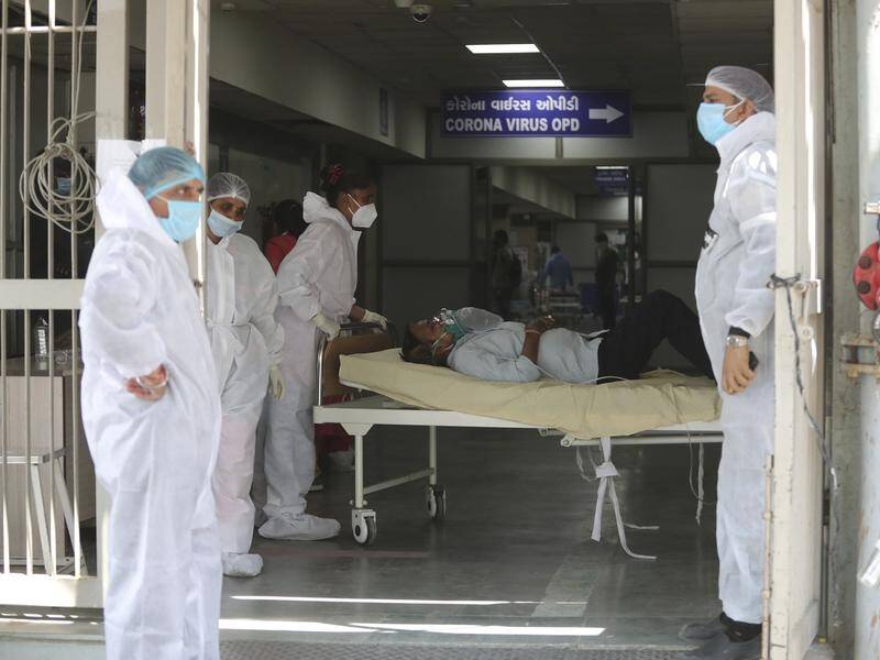 Indian hospitals are scrambling for beds and oxygen as COVID infections surge to a new daily record.