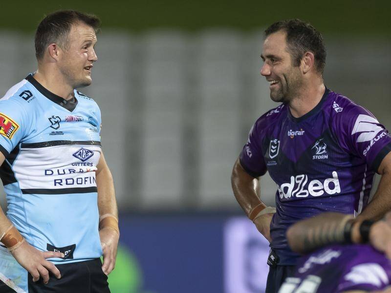 The break in the NRL season due to the coronavirus has enticed veteran Cameron Smith (r) to play on.