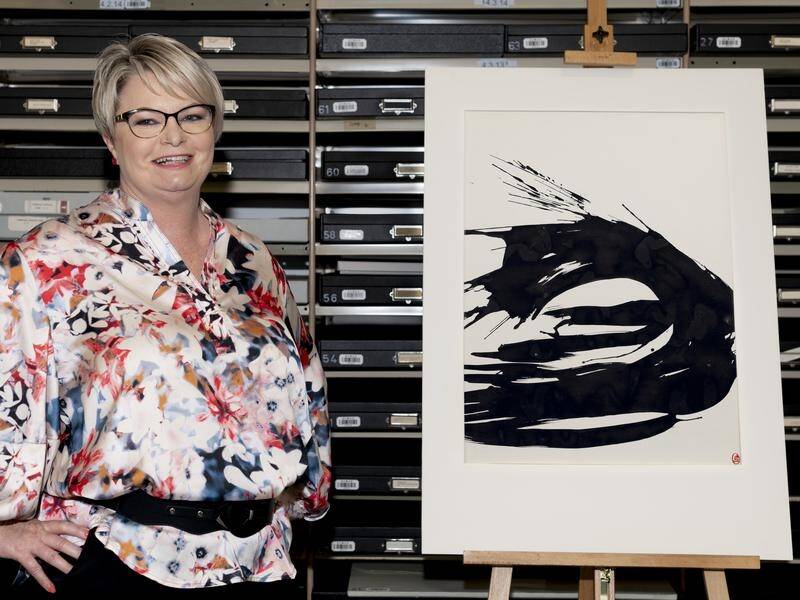 QVMAG's Tracy Puklowski with the ink drawing by two-time Archibald Prize winner Brett Whiteley.