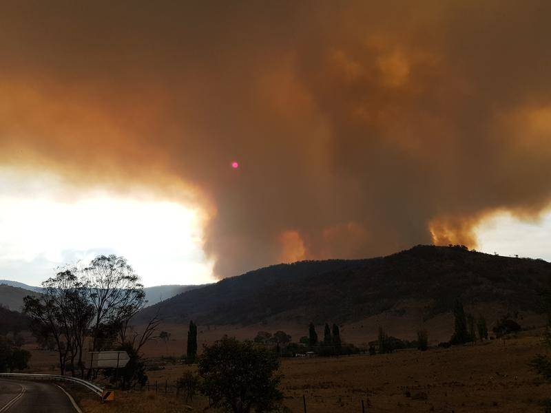 The fire south of Canberra is believed to have been started by a defence helicopter's landing light.