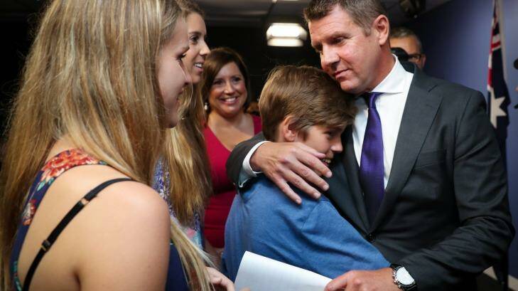 Mr Baird embraces his family after announcing his resignation.  Photo: Janie Barrett