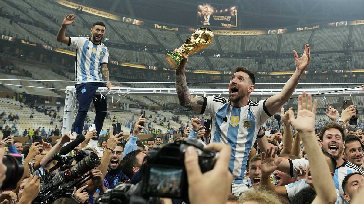 Lionel Messi hoists the trophy aloft after Argentina's win over France in the 2022 World Cup final.  (AP PHOTO)