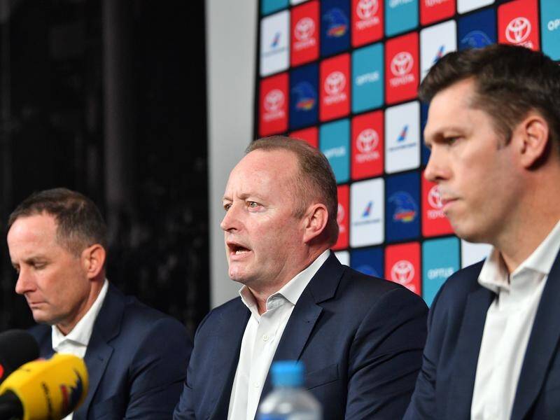 Adelaide AFL chairman Rob Chapman (C) says he will stand down after the Crows' 2020 season.