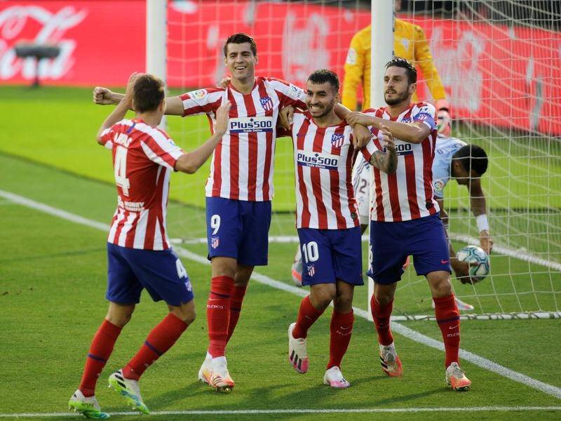 Alvaro Morata (2-l) celebrates Atletico Madrid's goal with teammates against Celta Vigo.