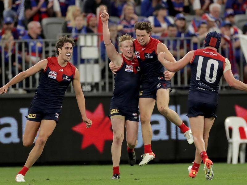 Melbourne are celebrating after ending a 57-year curse by winning the AFL grand final.