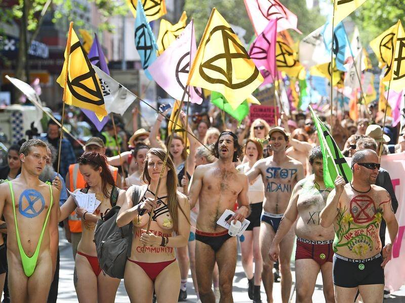 Activists from Extinction Rebellion stripped off their tops for a march through Melbourne.