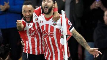 Former Southampton striker Charlie Austin (right) has signed with the Brisbane Roar.