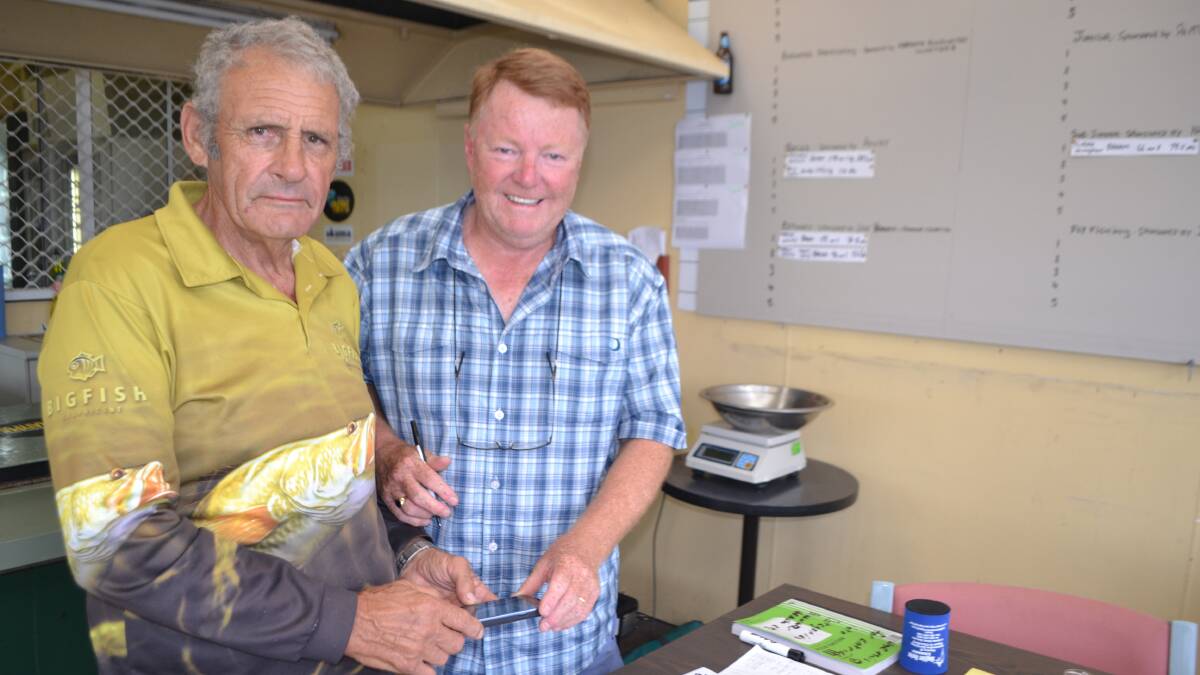 PHOTO FISH: Ron Hanson from the Nowra Sports Fishing Club records his catch and release bream with NSGFC weigh master  
