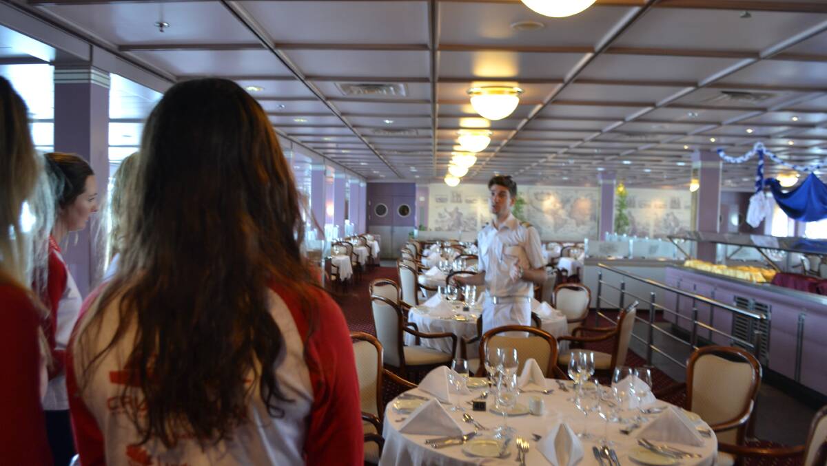 LEARNING THE ROPES: The cruise ship MV Astor’s customer service manager Chris White gave the Bega TAFE Tourism students a tour of his ship. Here they are in the Waldorf dining room.