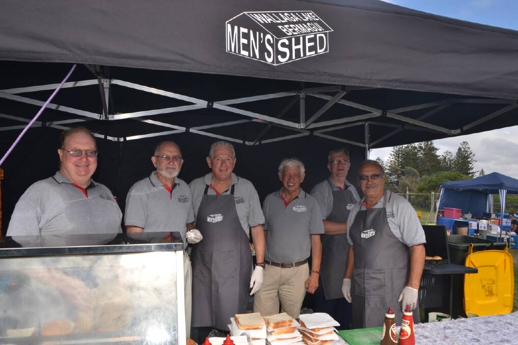 MEN’S SHED: Fergus McWhirter, Bruce Grimmond, Ian Bailey, Ted Ferguson, Steve Knight, Sergio Banados at the Wallaga Lake Bermagui Men’s Shed barbecue stand. 