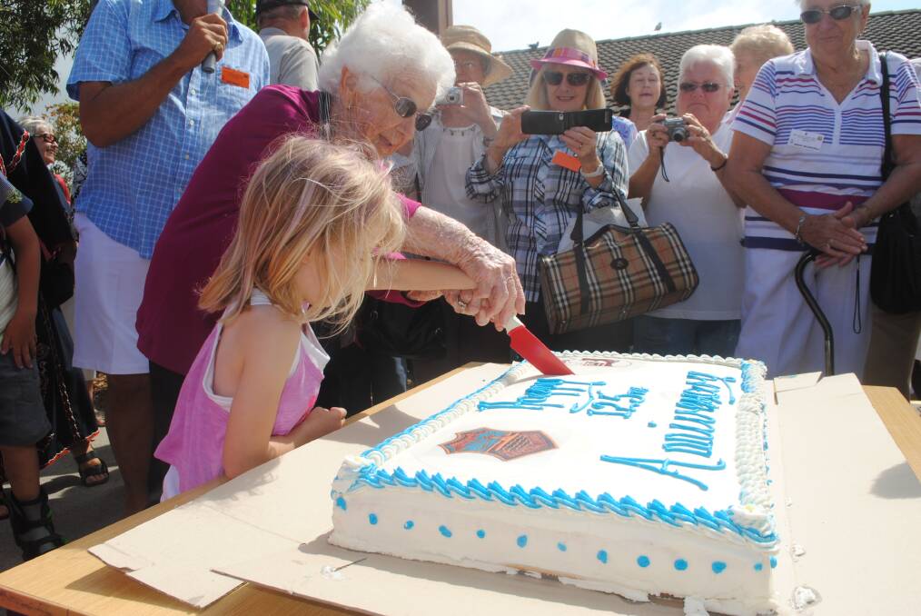CUTTING: The oldest and youngest Narooma Public School students were chosen to cut the cake. Pictured are 92-year-old Rene Bennett and the youngest Narooma Public School student Caprice Rose.