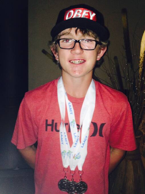 
LITTLE ATHLETE: Connor Griffiths with his three silver medals won at the state championships for Little Athletics.
 