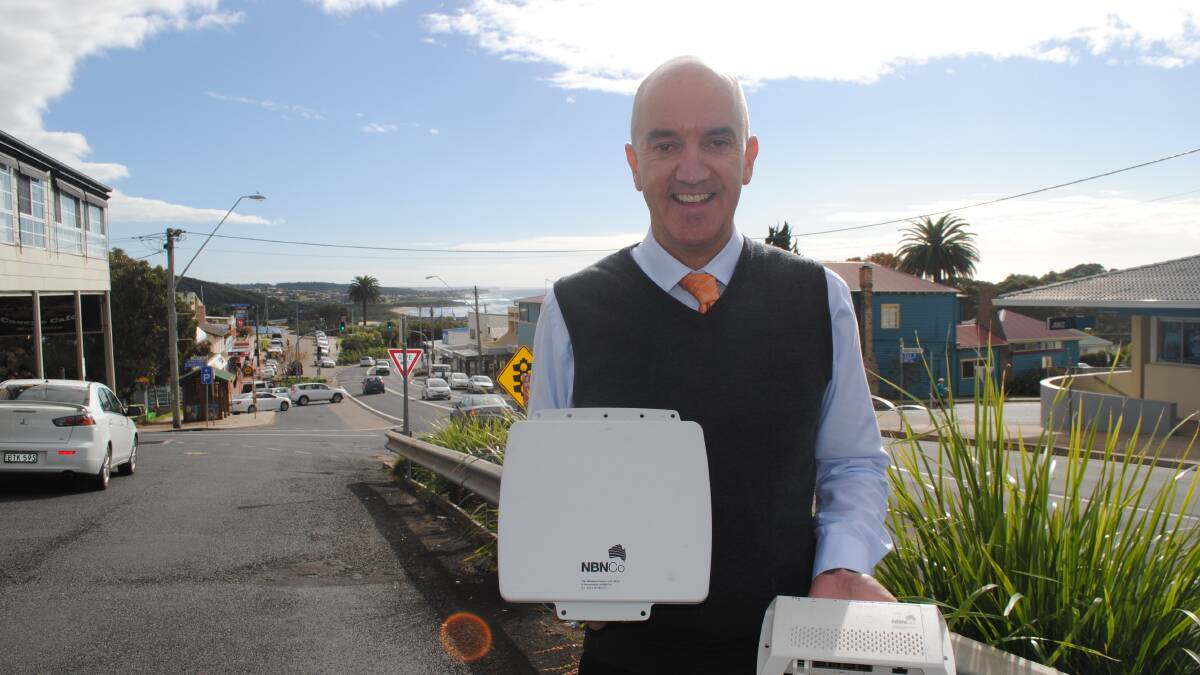 GOING WIRELESS: NBN Co community relations advisor Tony Gibbs showing the wireless antenna and a connection box which will be installed at premises receiving the fixed wireless broadband. 