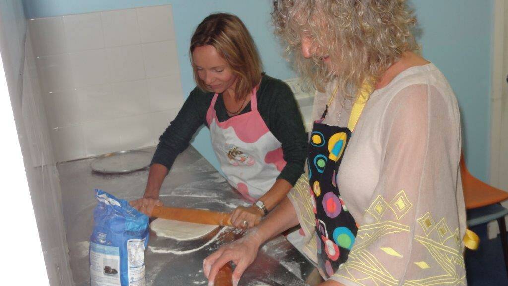 P&C FUN: Rachael Niemoeller and Jo Westoll making pizza at this year’s Narooma Public School 125th Anniversary celebration reunion. 