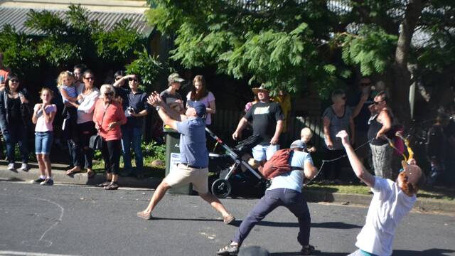EGG TOSSERS: Winners of one of the final heats of the Tilba Festival Easter egg toss Nigel Jackson of Mystery Bay makes a lunge for his egg.