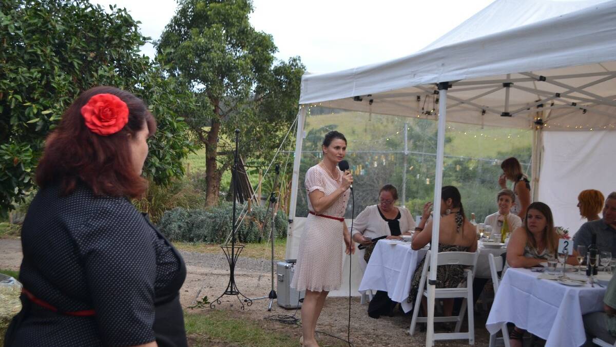 THE HOST: Event organiser Christine Montague and host Erica Dibden from Tilba Milk welcome the guests seated in the dairy farm garden on Saturday night.