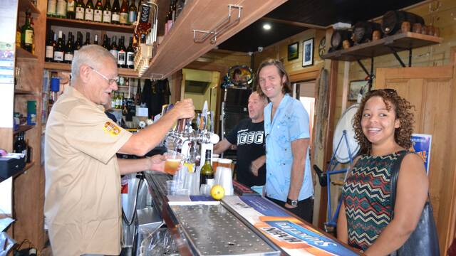POPULAR PUB: The Dromedary Hotel is always popular at the Tilba Festival on Easter Saturday. The back bar was open to but at the front bar are bartender Mardy Aye and festivalgoers Tom Noonan of Narooma and Simone Jordan on Canberra.