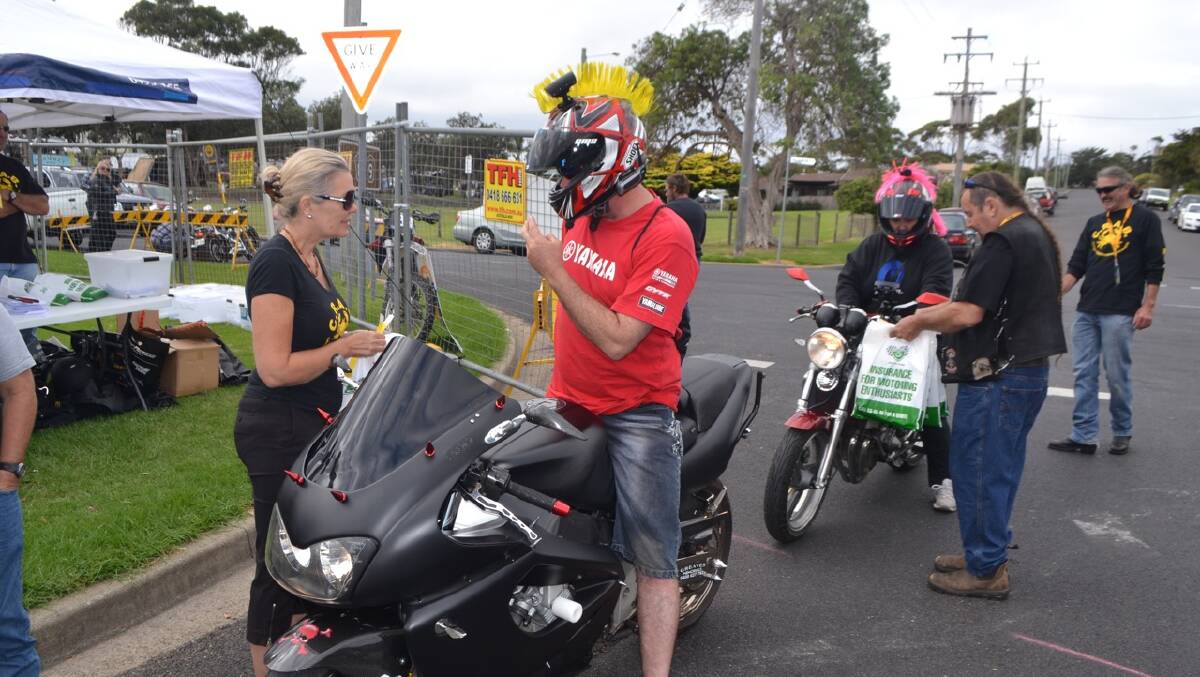 GOULBURN RIDERS: Bermagui CRABs member Sallie Hand greets John and Rachael Greaves from Goulburn who rode all the way to Bermagui the day before, not with the Mohawks though! 