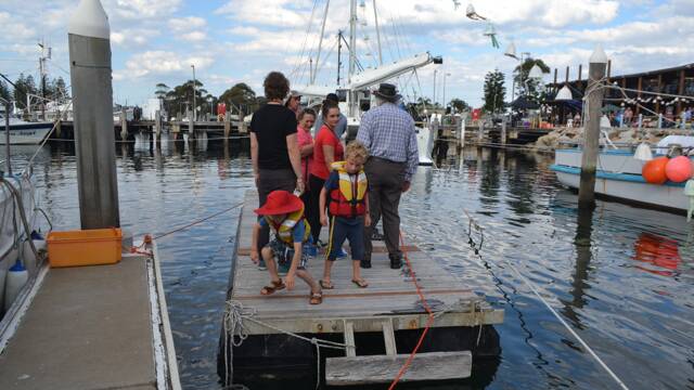 PUNT TRIP: The Welcome to Country crew gets taken across to the stage on the MV Pelican on the Bermagui harbour at the Four Winds Festival community concert.