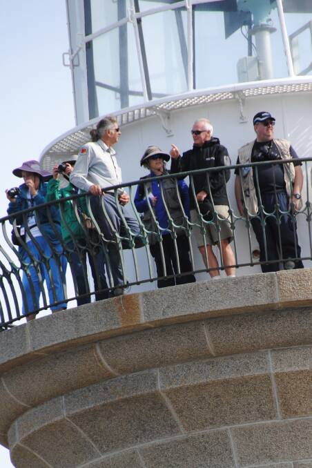 IN ELEMENT: In their element, the US Lighthouse Society group up and inside Montague Island Lighthouse on Monday. 