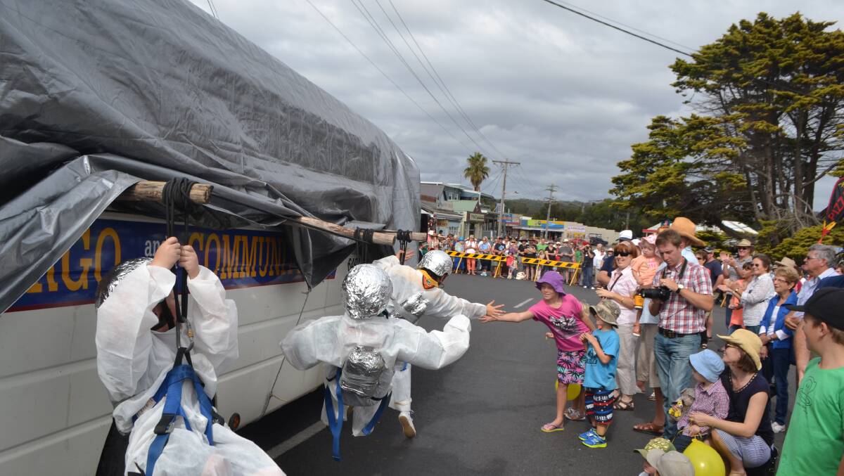 SPACE SCOUTS: "Cobargo Space Scouts" complete their extra-vehicular activity during the Bermagui Seaside Fair "Out of this World" parade. Hanging on the space ship are Annalise Ayliffe, Taran Gross and Sam Hackett. 