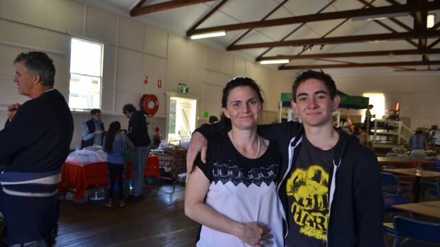 
MOTHER AND SON: Erica Dibden and son Jonah of the ABC Cheese Factory and Real Tilba Milk the local produce display in the Big Hall at the Tilba Festival on Easter Saturday.
