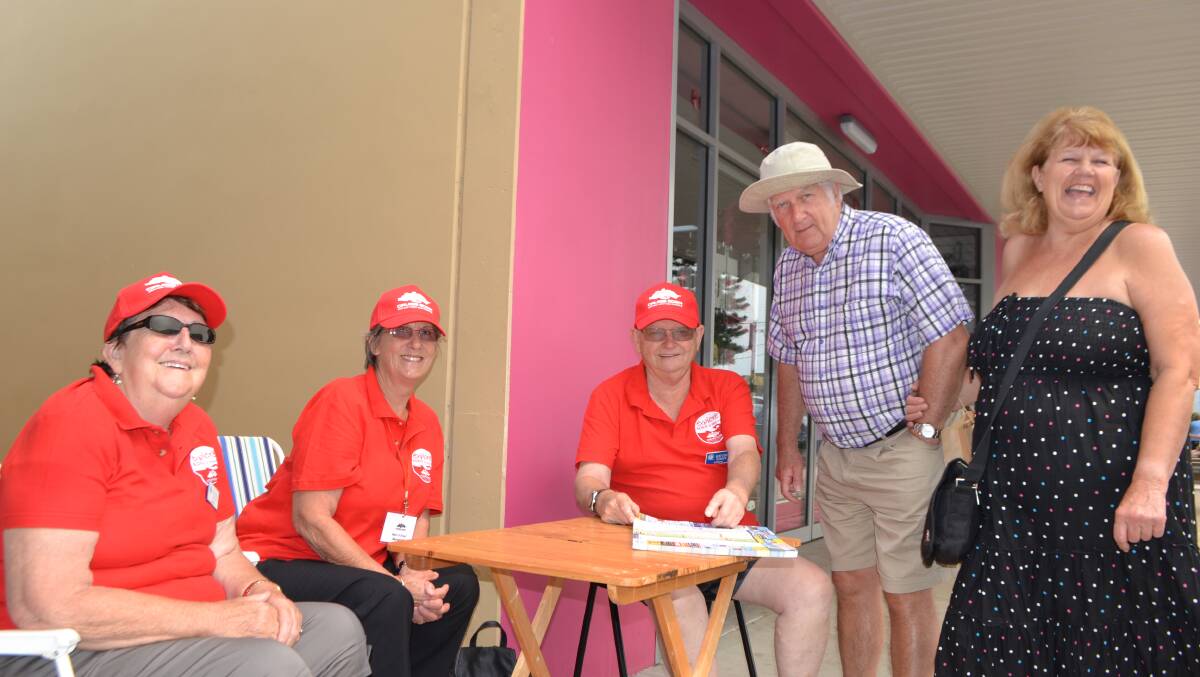 FRIENDLY VOLUNTEERS: Cruise Eden volunteers Valma Barber, Margaret Baigent and Kevin Barber set up on the main street to help passengers such as Valerie and Ridgeway Smith from Southampton, England. 