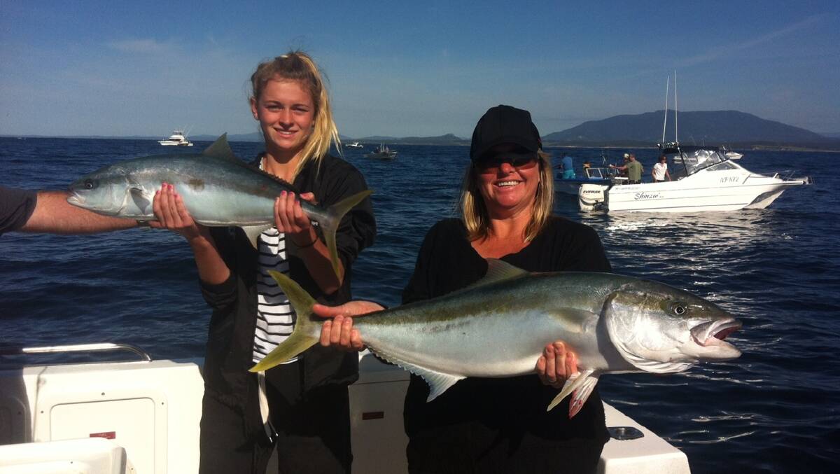 GIRLS’ KINGS: Tarni and Leanne Magyar with their kingfish on Thursday morning on Nitro operated by Benny and Nick from Charter Fish Narooma. 