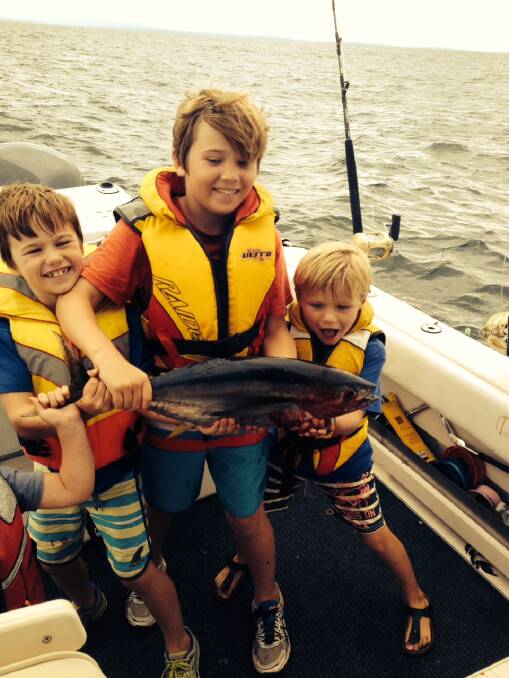 LITTLE YELLOWFIN: Gus Patmore and his little yellowfin caught on Brett McDonald’s boat on Sunday afternoon off Bermagui. 