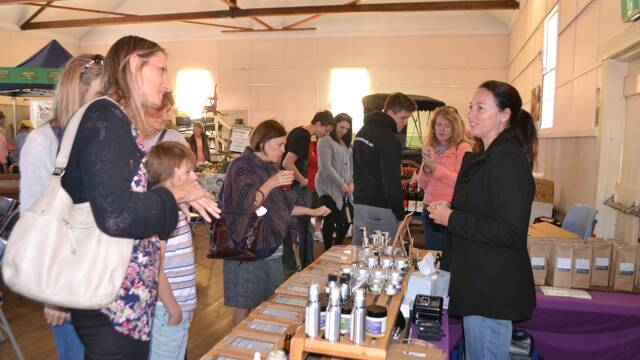 ORGANIC TREATMENT: Kay Saarinen of Saarinen Organics with the crowd in the local produce display in the Big Hall at the Tilba Festival on Easter Saturday.