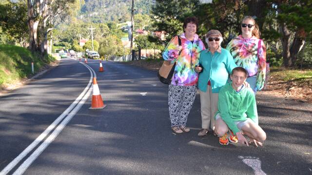 
FOLLOW FOOTSTEPS: Following the painted foot steps down to the Tilba Easter Festival is Albury family and regular Narooma visitors mum Louise Parker, grandma Sylvia and kids Carter and Kelsey.
