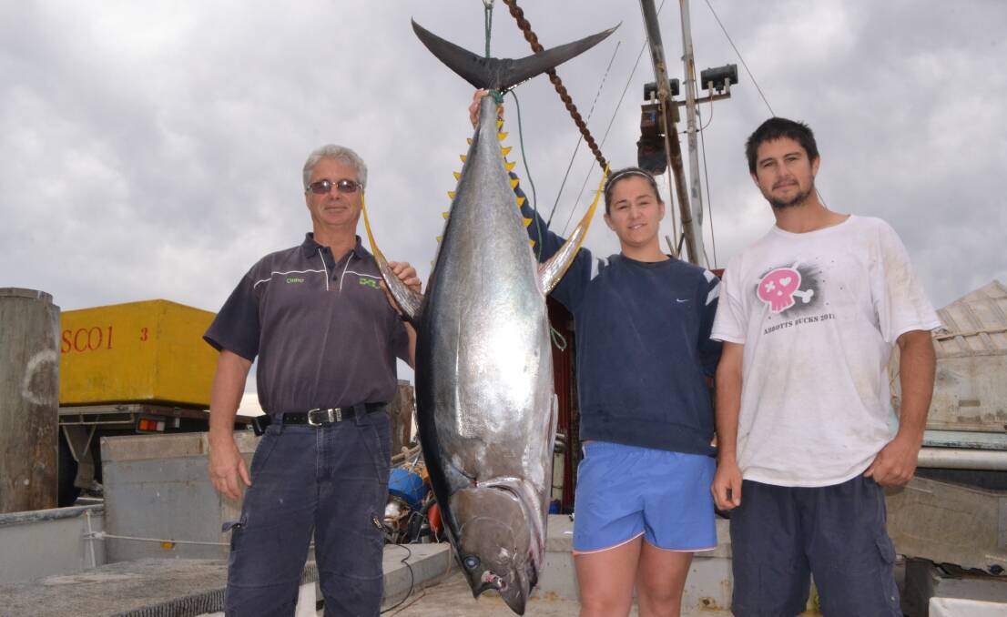 FISCO UNLOADING: HuntFest organiser Onno DeSmeth with Todd and Hayley Abbott unloading the yellowfin tuna catch on board the Fisco. 