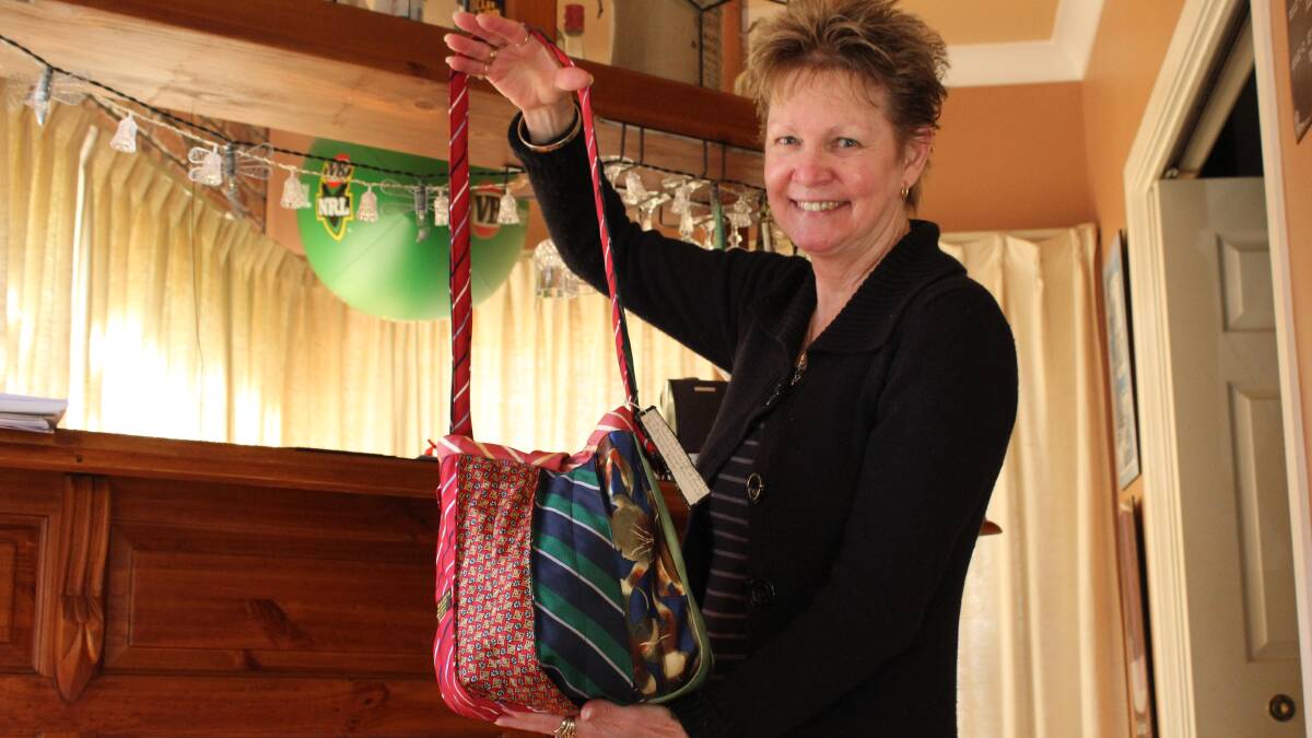WORTHWHILE FASHION: Karen Baker with one of the handbags made out of ties that are sold to help fight breast cancer. 