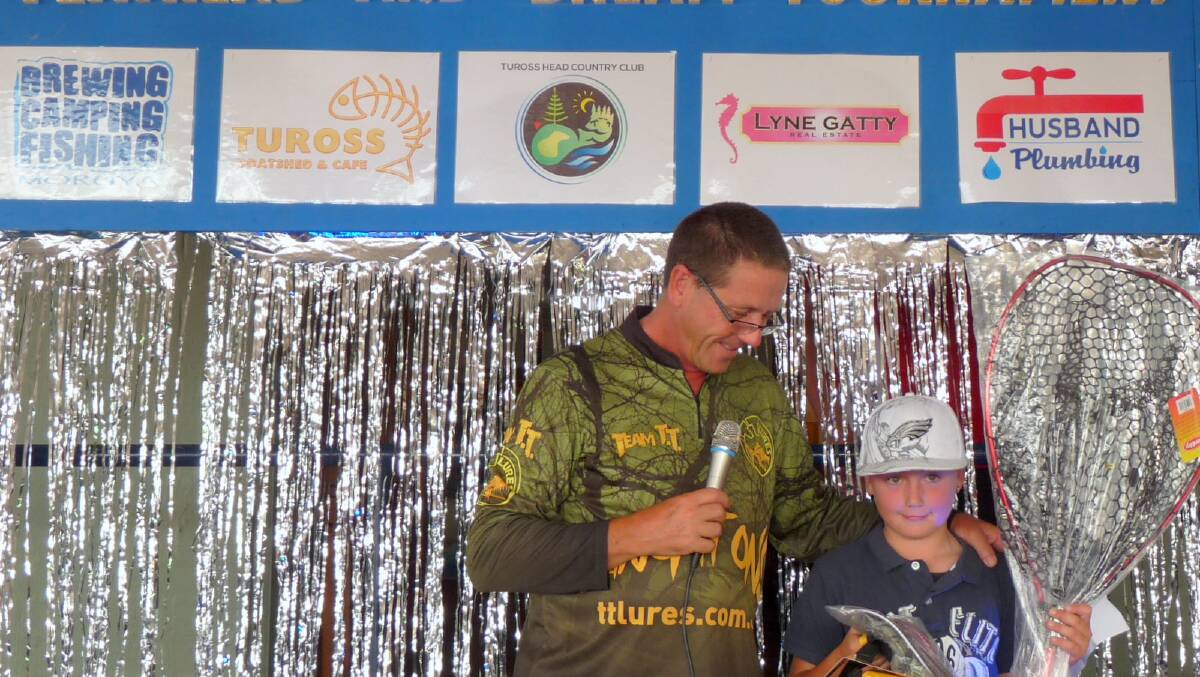 YOUNG WINNER: Jake Mikolic of Narooma caught the biggest bream, beating many older more experienced anglers in the process, and is pictured getting his prizes from comp organiser John Suthern.
