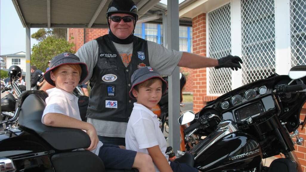 HOG BEAST: Former footballer Ian Schubert showed off his Harley Davidson to Paul Mette and Jarrod Duck when the league legends rode into Narooma Public School.