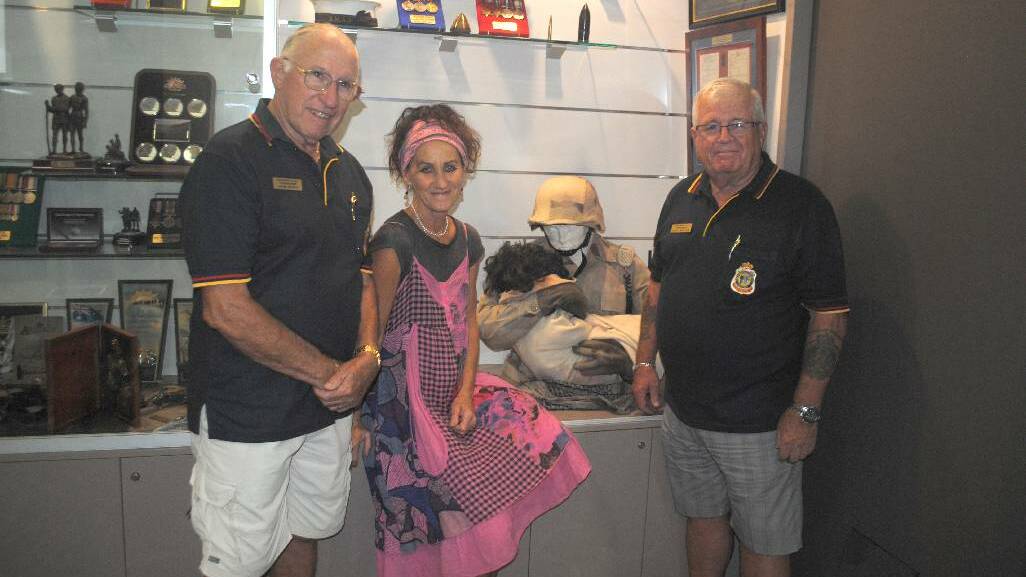 HEARTFELT SCULPTURE: Narooma RLS sub branch treasurer Jon King, with artist Jenni Bourke and RSL sub branch president Paul Naylor with the deeply moving sculpture of and American Major trying to save a wounded child.