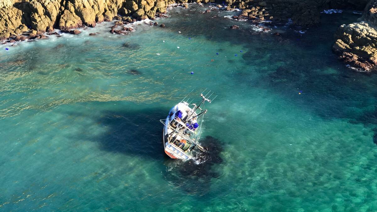 The stricken fishing trawler off Bengunnu Point on the morning of Saturday, July 7. Photo: Westpac Life Saver Rescue Helicopter.