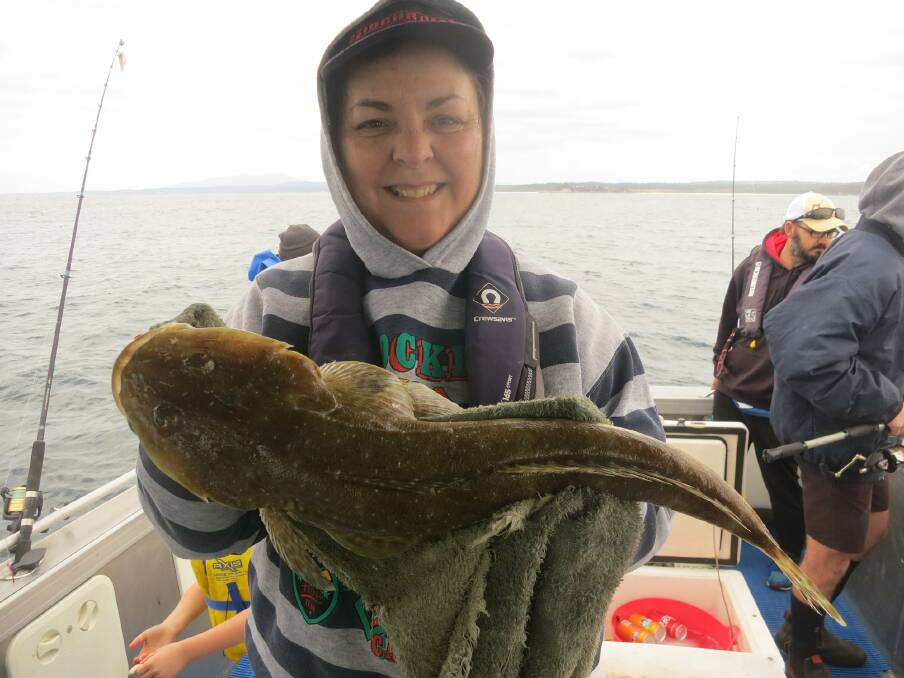 GREAT CATCH: Angela from Dalmeny nabbed this impressive 57.5-centimetre sand flathead over the weekend. Photo: Narooma Fishing Charters - John Moore.