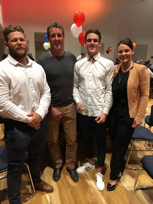 Tully Wilton with his parents Glenn and Vanessa, and Narooma Devils first-grade coach Todd Ayers.