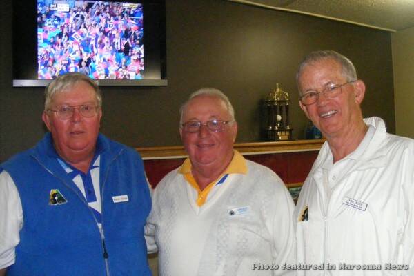 PAIRS WINNERS: Winter Carnival Men's Pairs winners Bruce Gatford (skip) and Lyal Allen from Rye, in Victoria, are congratulated by Warren Bender, president of the Narooma Men’s Bowling Club.