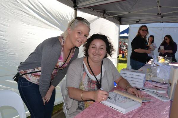 MASTER CHEF: Innaugural MasterChef winner signing her book at this year's Narooma Oyster Festival.