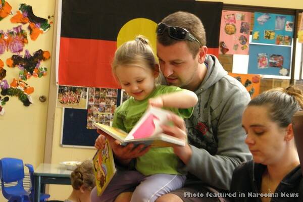 DADS READ: One of the parents Robbie Brown reading to Krislyn.